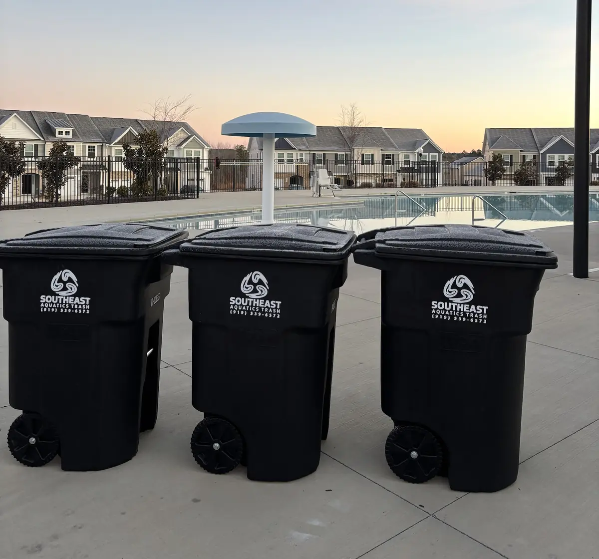 Southeast Aquatics Trash carts staged at a community pool deck at sunrise