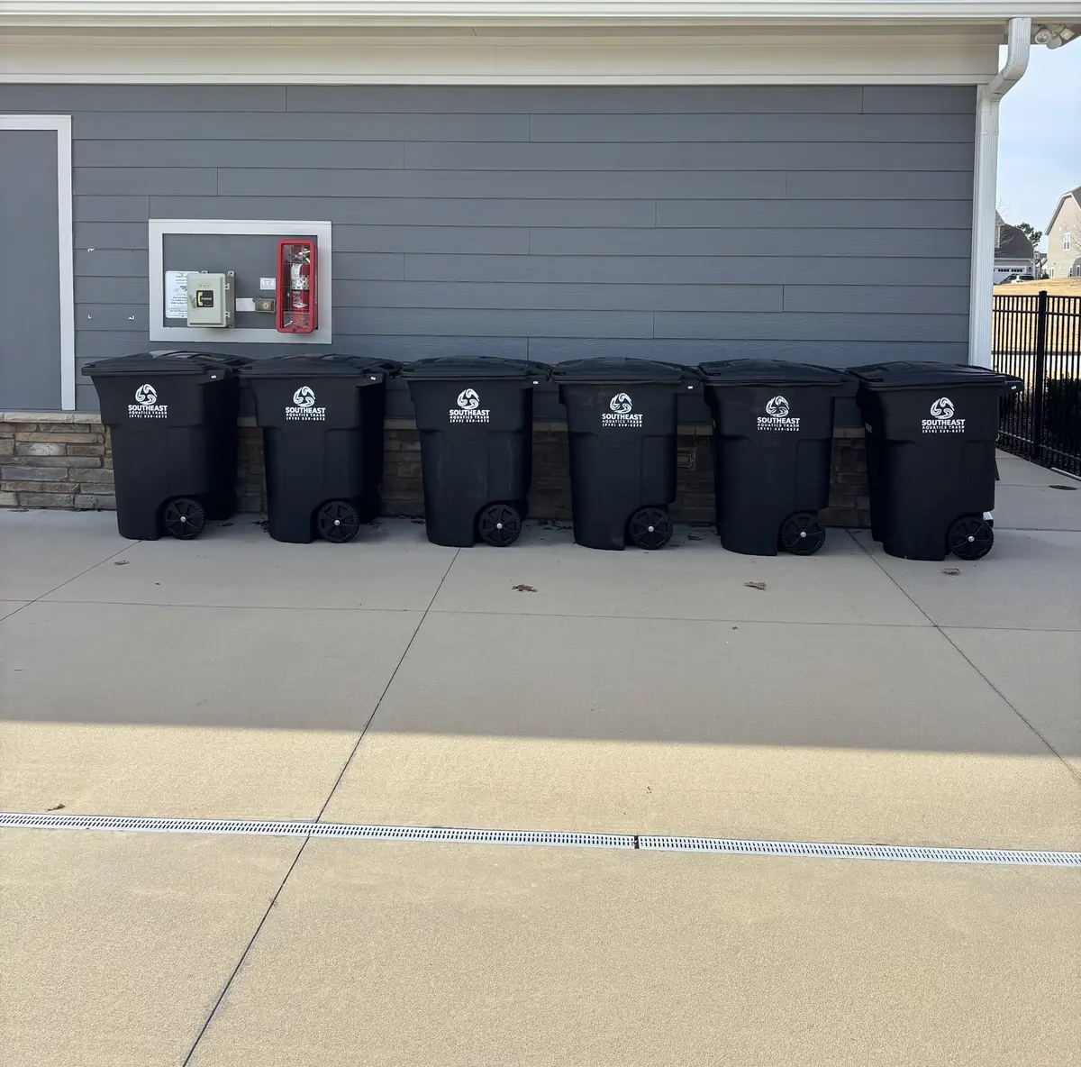 Six Southeast Aquatics Trash carts lined up at a community clubhouse